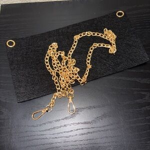 Turn your clutch into a crossbody. Gold Chain with Black Fabric Panel